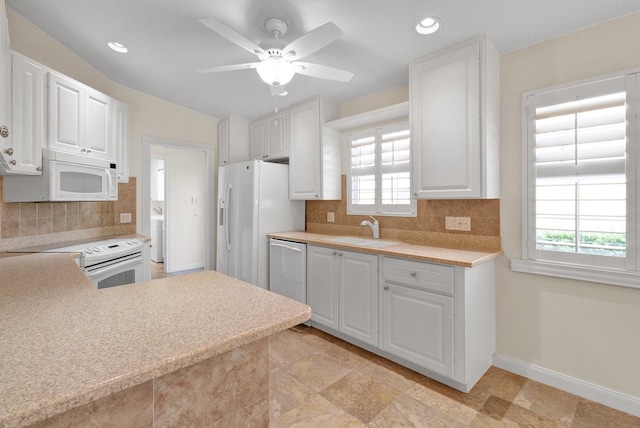 kitchen with decorative backsplash, white cabinets, sink, and stainless steel appliances