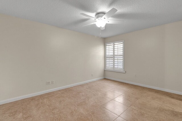 empty room featuring ceiling fan and a textured ceiling