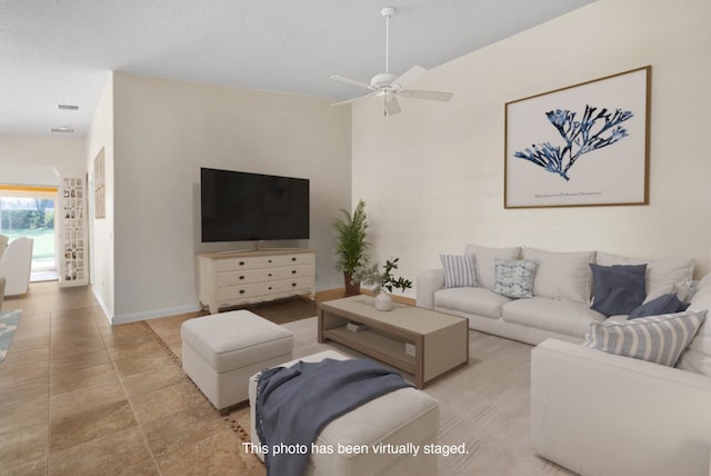 living room featuring ceiling fan, a textured ceiling, and lofted ceiling