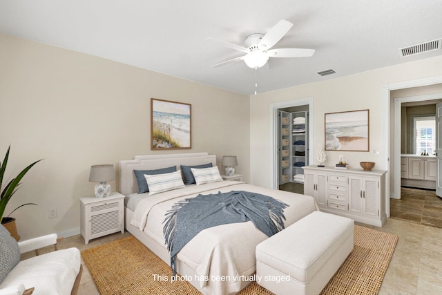 bedroom with ceiling fan, a closet, and a walk in closet