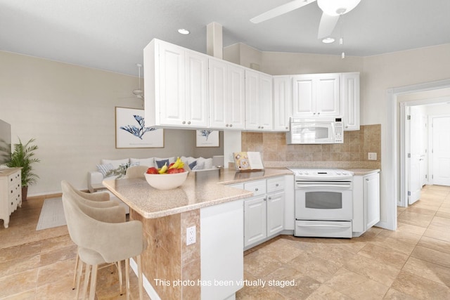 kitchen with white cabinetry, kitchen peninsula, decorative backsplash, and white appliances