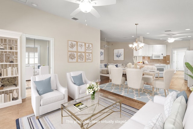 tiled living room with ceiling fan with notable chandelier