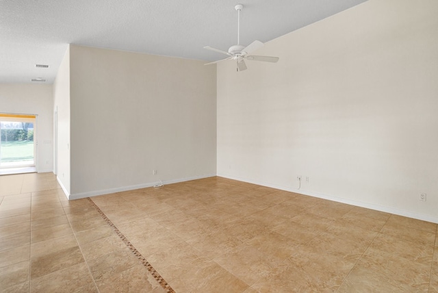 empty room featuring lofted ceiling, a textured ceiling, and ceiling fan