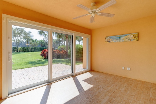 entryway featuring ceiling fan, a healthy amount of sunlight, and light hardwood / wood-style flooring