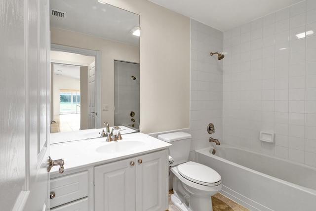 full bathroom featuring vanity, toilet, and tiled shower / bath