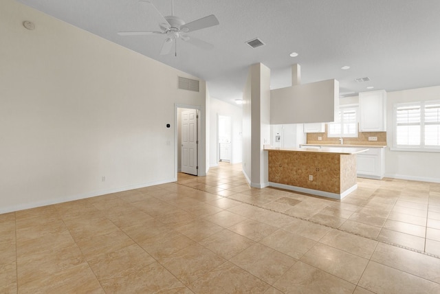 interior space with light tile patterned flooring, ceiling fan, and lofted ceiling