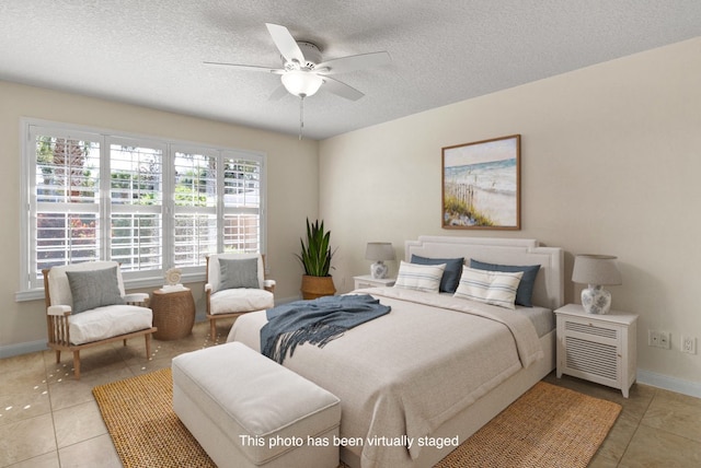 bedroom featuring ceiling fan, a textured ceiling, and light tile patterned floors