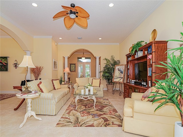 living room with ornamental molding, ceiling fan, a textured ceiling, and ornate columns