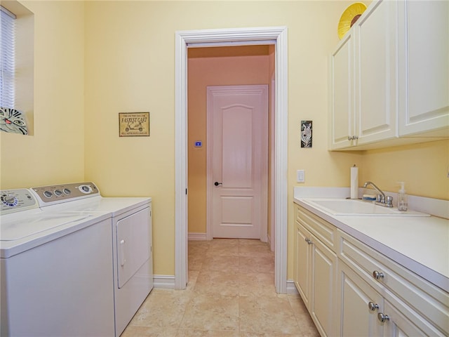 laundry area with cabinets, light tile patterned floors, sink, and independent washer and dryer