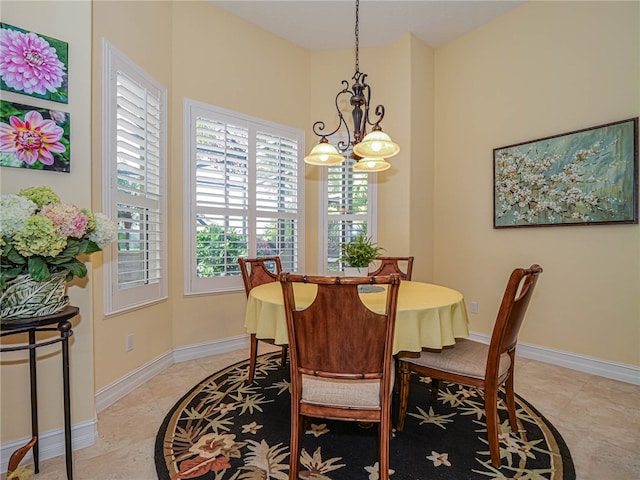 tiled dining space with an inviting chandelier