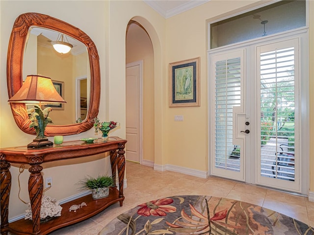 tiled entrance foyer with a wealth of natural light, french doors, and crown molding