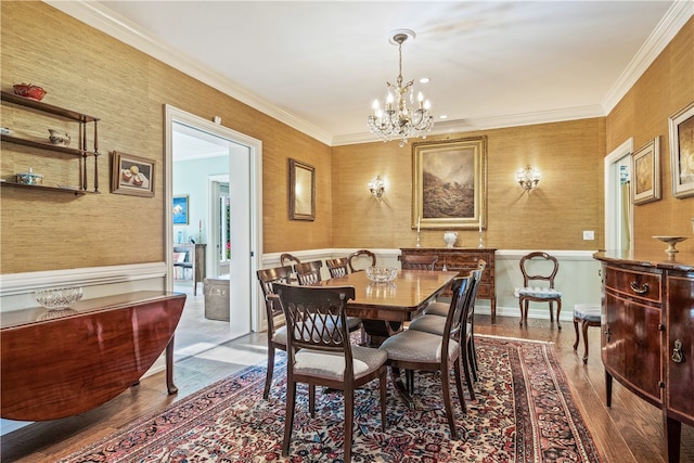 dining area featuring a chandelier, wood-type flooring, and ornamental molding