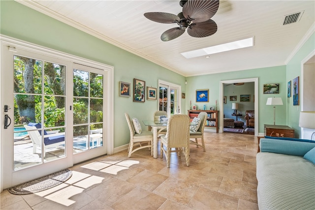 dining area featuring wooden ceiling, a skylight, ceiling fan, and ornamental molding