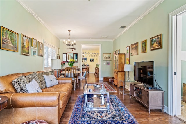 living room featuring dark hardwood / wood-style flooring, crown molding, and a notable chandelier