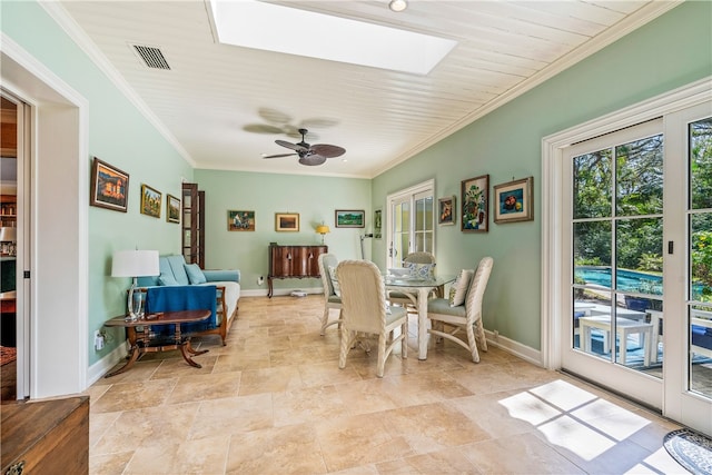 dining space featuring ceiling fan and ornamental molding