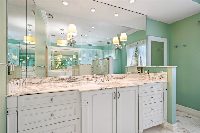 bathroom with vanity, a shower with door, and crown molding