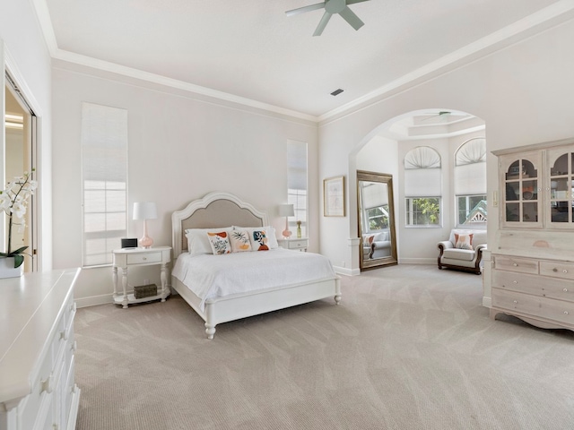 bedroom with ceiling fan, ornamental molding, and light colored carpet