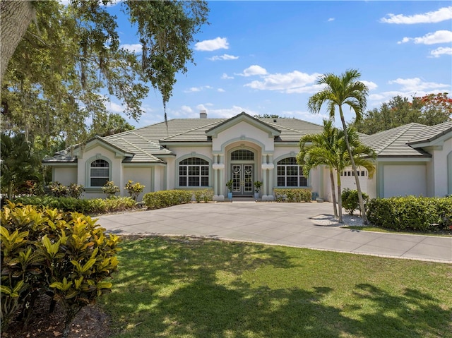 single story home featuring a front lawn and french doors