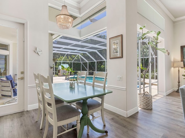 dining area with hardwood / wood-style flooring and crown molding