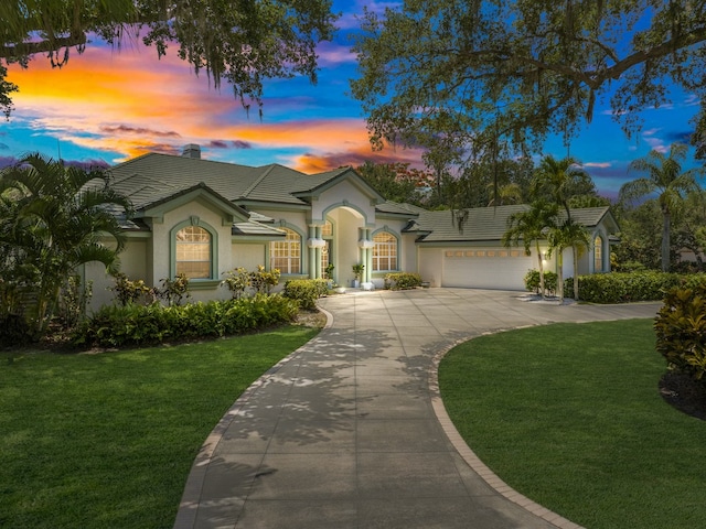 view of front facade with a lawn and a garage