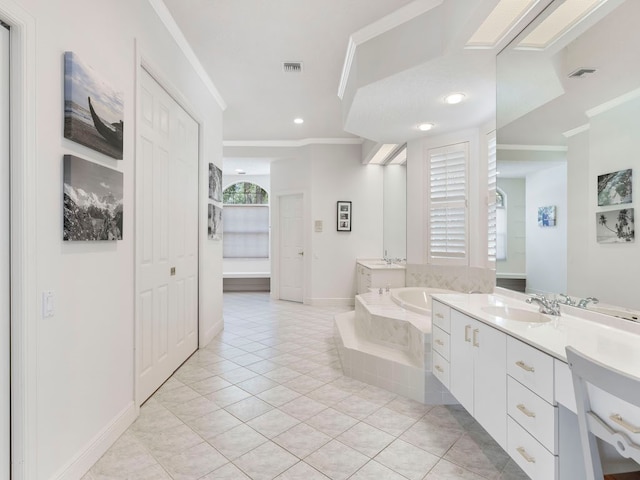 bathroom featuring vanity, tile patterned flooring, a healthy amount of sunlight, and tiled tub