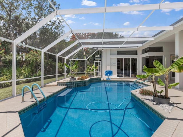 view of swimming pool featuring a lanai, a patio, and a jacuzzi