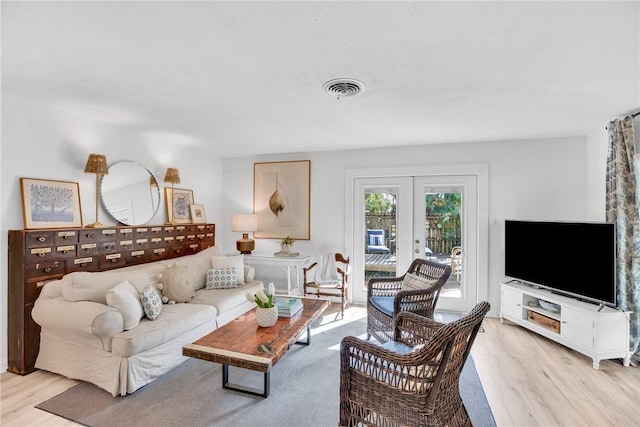 living room with light hardwood / wood-style floors and french doors