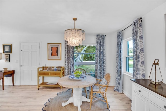 dining room with a chandelier and light hardwood / wood-style floors