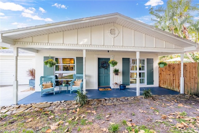 back of house featuring covered porch