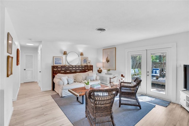 living room featuring light hardwood / wood-style floors and french doors