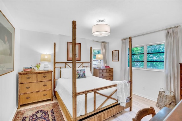 bedroom featuring multiple windows and light wood-type flooring