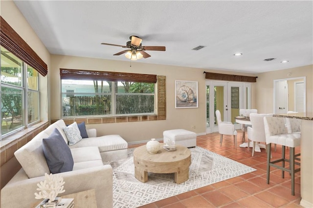 living room with ceiling fan, tile patterned floors, and french doors