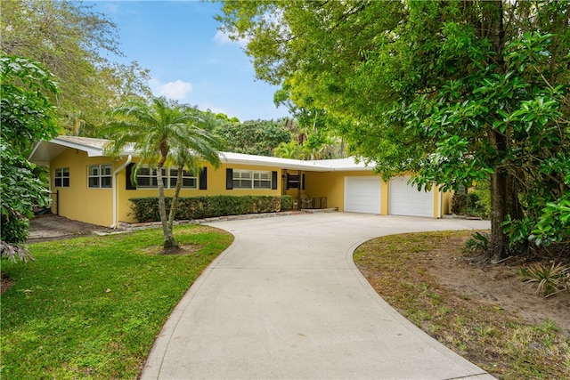 ranch-style home with a garage and a front lawn