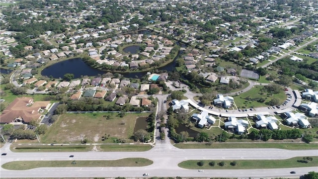 birds eye view of property featuring a residential view and a water view