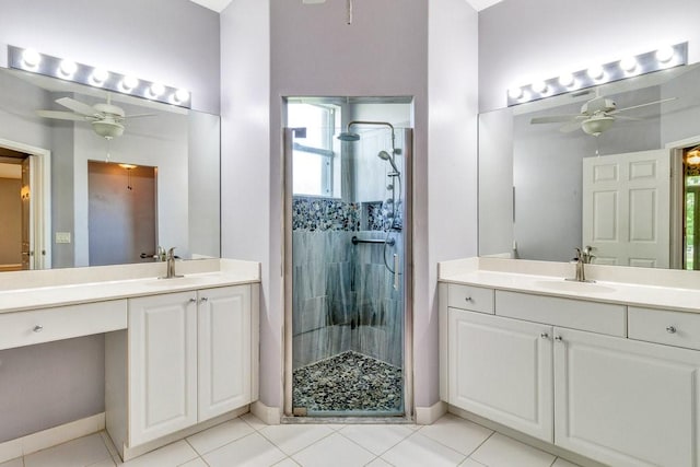 full bath featuring a stall shower, two vanities, a sink, and a ceiling fan