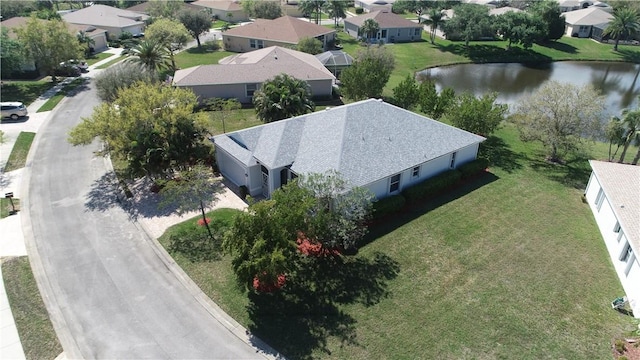 drone / aerial view with a water view and a residential view