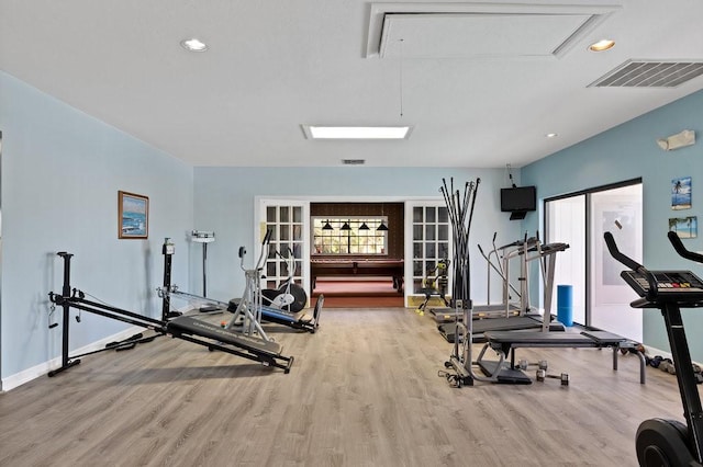 exercise room featuring recessed lighting, wood finished floors, visible vents, baseboards, and attic access