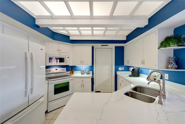 kitchen with white cabinets, white appliances, beamed ceiling, and sink