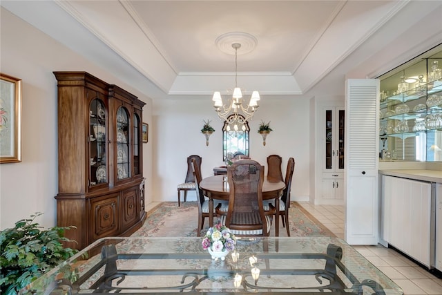 dining area with plenty of natural light, light tile patterned floors, an inviting chandelier, and a tray ceiling