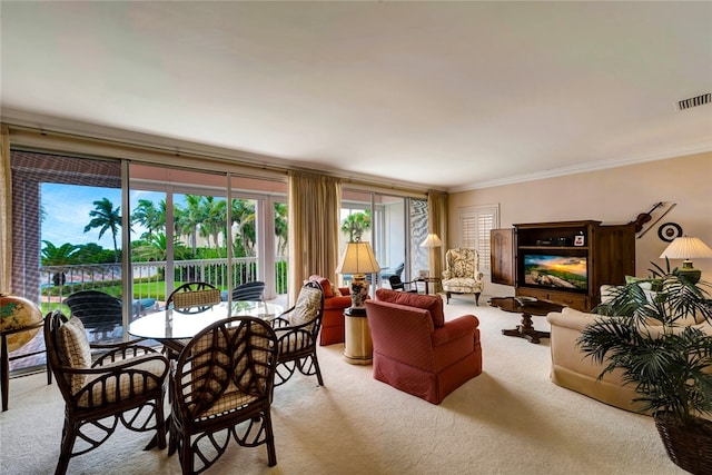 dining room with light carpet and ornamental molding