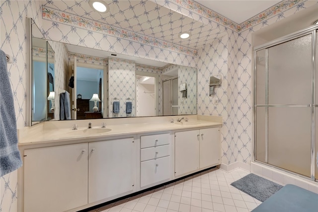 bathroom with tile patterned flooring, an enclosed shower, and vanity