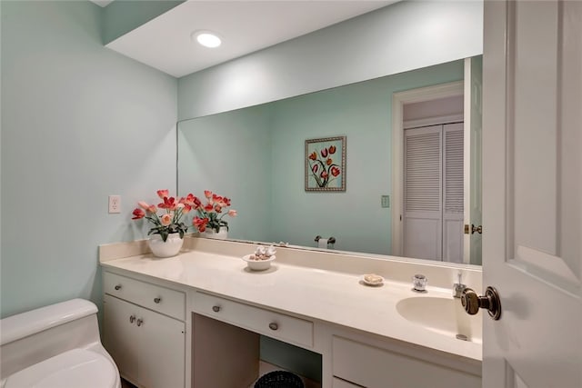 bathroom featuring vanity and toilet