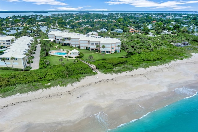 bird's eye view with a water view and a beach view