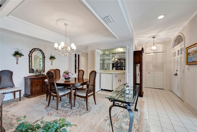 dining area featuring an inviting chandelier, light tile patterned floors, ornamental molding, and a raised ceiling