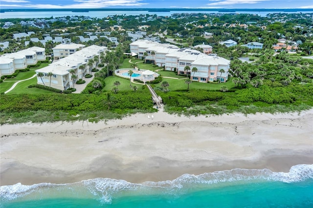 birds eye view of property featuring a view of the beach and a water view