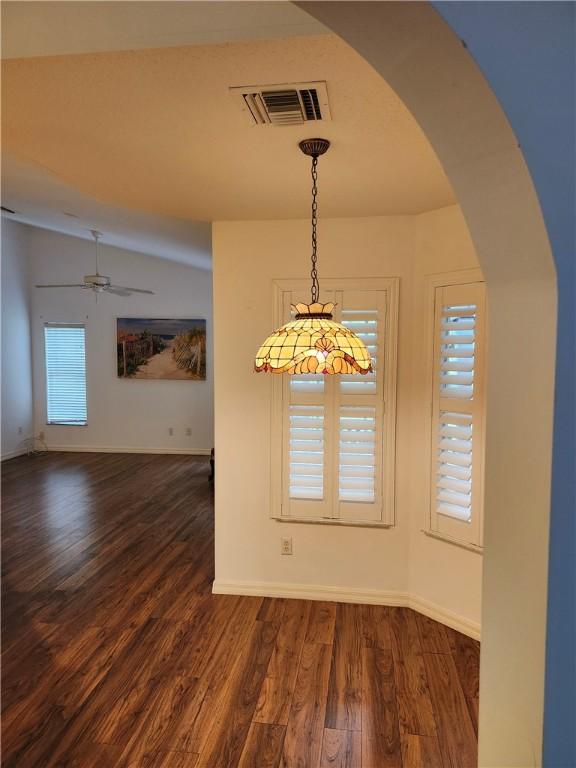 3865 8th Pl, Vero Beach, FL 32960 - unfurnished dining area with a ceiling fan, dark wood-style floors, and arched walkways