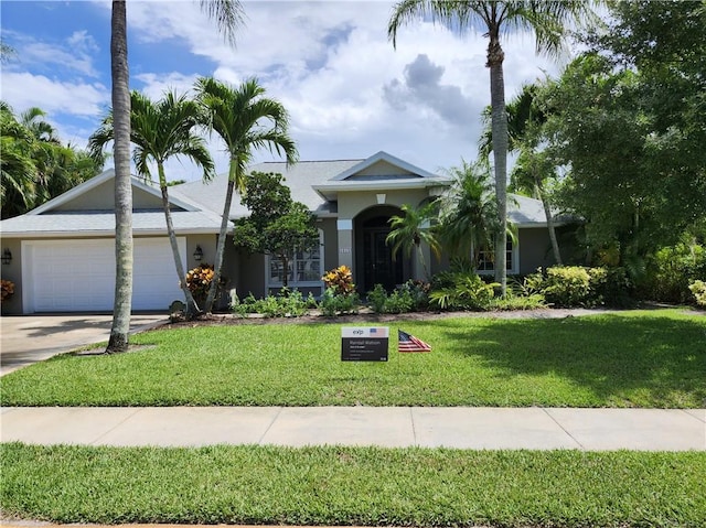 3865 8th Pl, Vero Beach, FL 32960 - ranch-style house with driveway, a garage, stucco siding, and a front yard