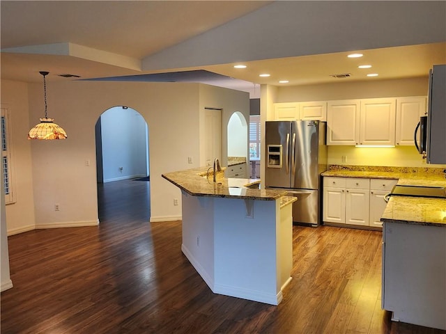 3865 8th Pl, Vero Beach, FL 32960 - kitchen with stainless steel refrigerator with ice dispenser, arched walkways, stove, black microwave, and dark wood-style flooring