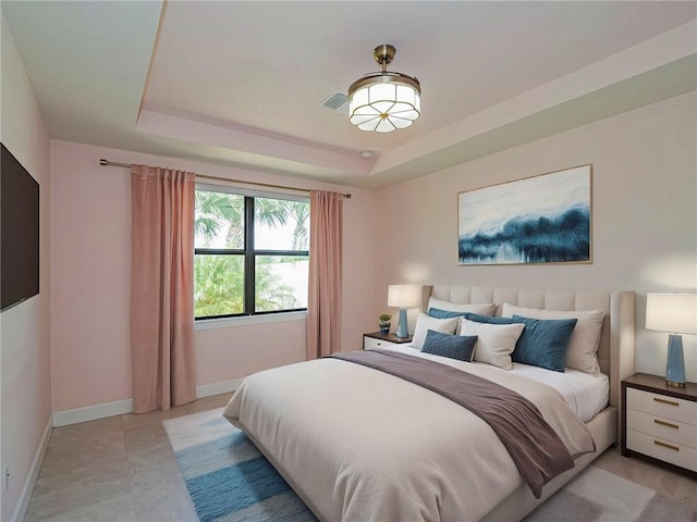 4348 Beauty Leaf Cir, Vero Beach, FL 32967 - bedroom with visible vents, baseboards, and a tray ceiling