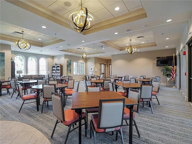 4348 Beauty Leaf Cir, Vero Beach, FL 32967 - dining room featuring visible vents, light colored carpet, a chandelier, and a tray ceiling